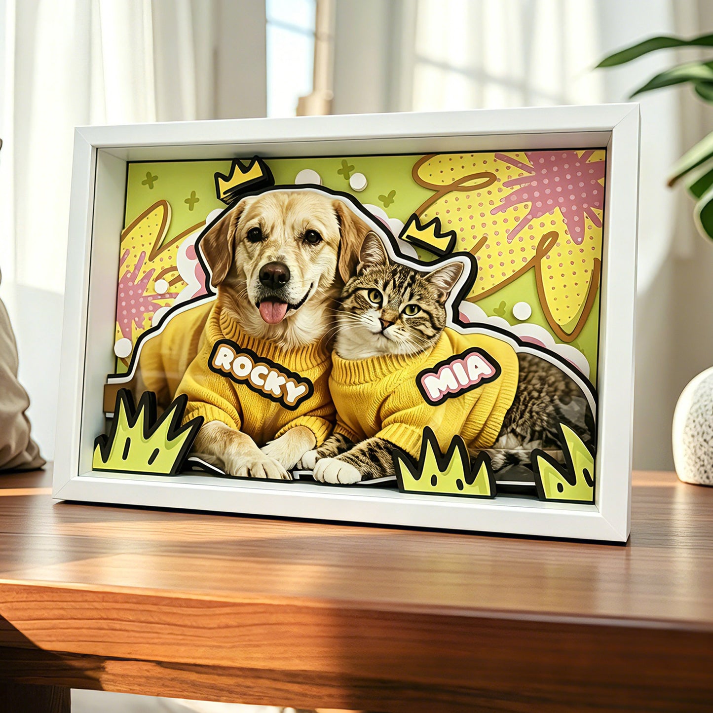A beautiful custom 3D layered dog and cat framed art sitting on a wooden table in a bright modern room.